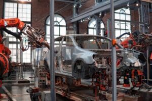 A car being built by a robot in a car manufacturing factory