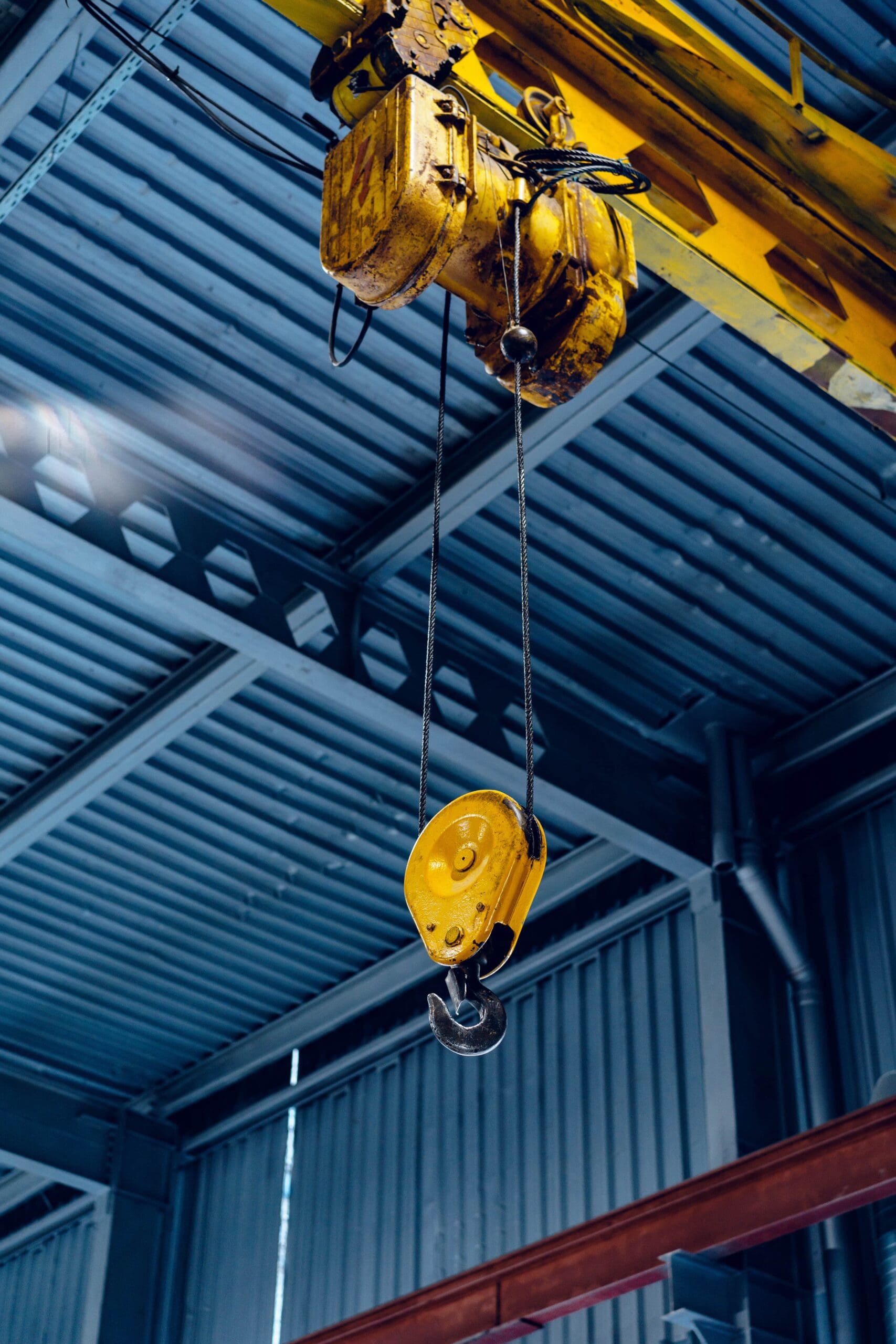 an industrial crane hook in a factory building