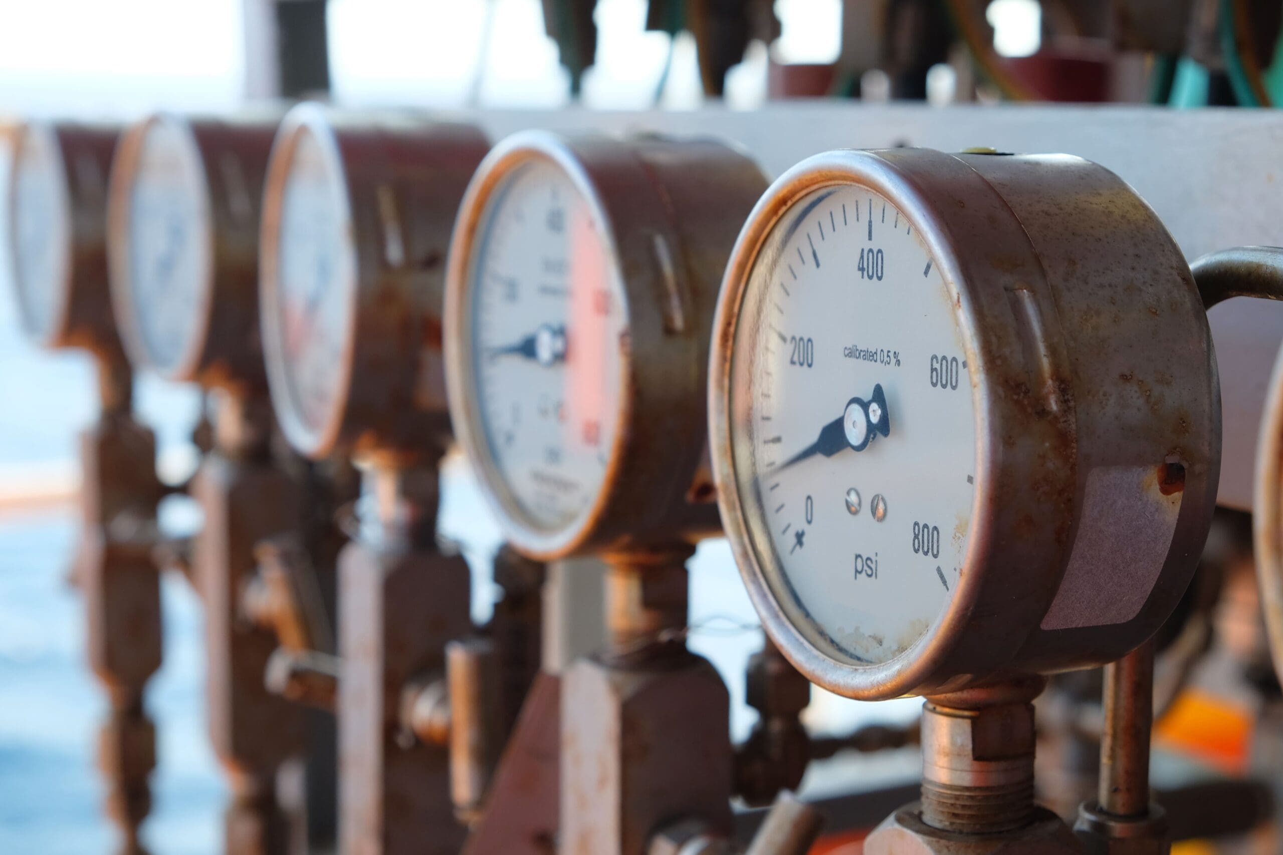 A close up image of a row of metal pressure gauges at different measurements