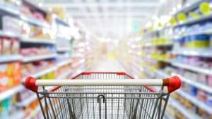 Shopping trolley down a supermarket aisle