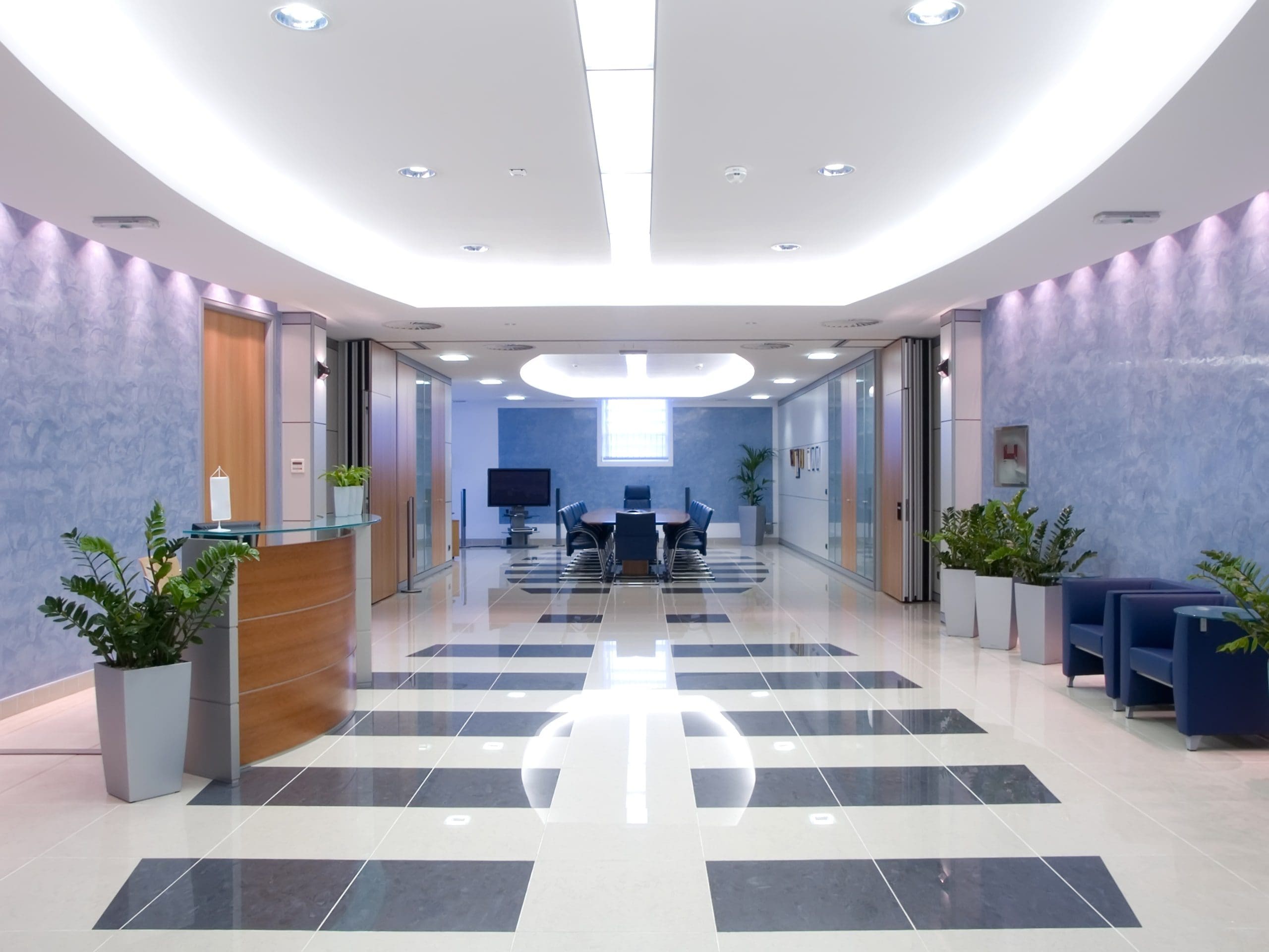 Reception of modern commercial office building with bright lighting and planting